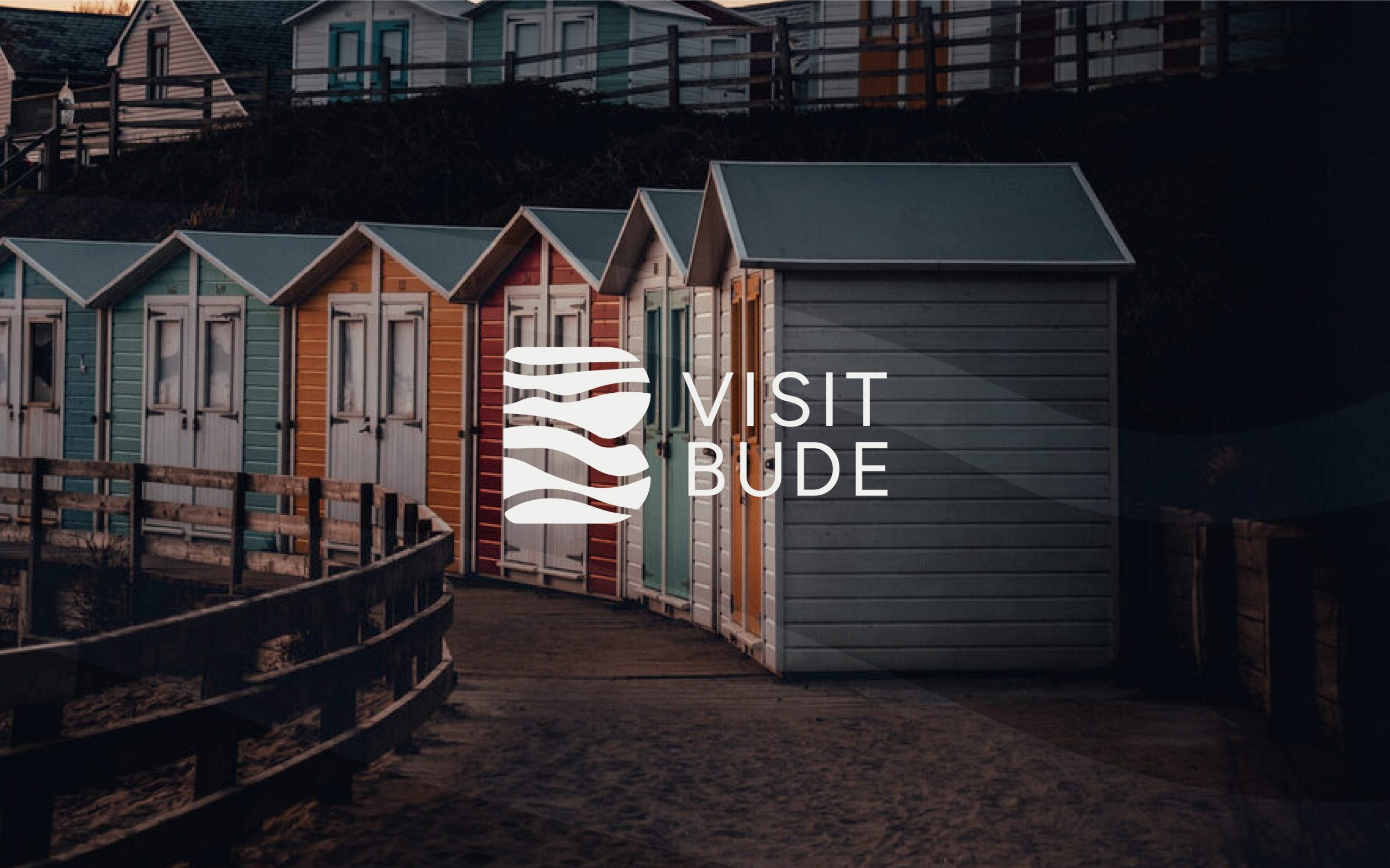 Visit Bude brand with beach cabins in the background