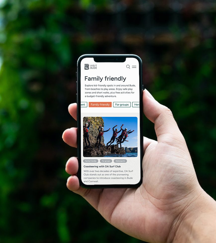 Visit Bude website on an iphone being held outside